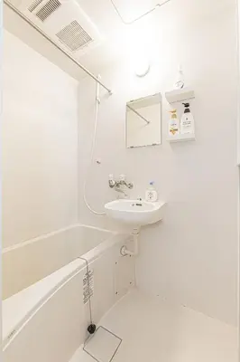 a white bathroom with a sink and a bath tub at 67 Apartment Hotel Asakusa in Tokyo