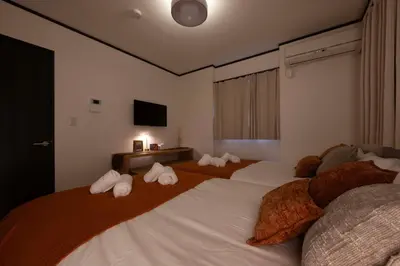 a bedroom with two beds with stuffed animals on them at All Good Stay KAMEARI in Tokyo