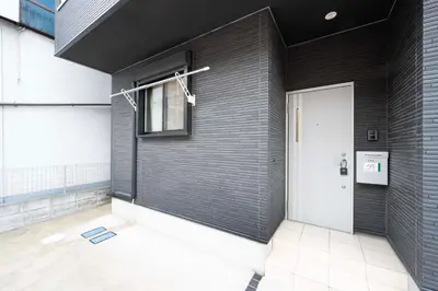 a building with a white door and a window at All Good Stay KAMEARI in Tokyo