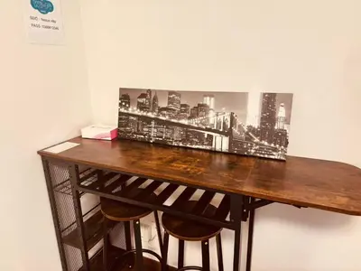 a desk with a picture of a city on the wall at Nexus Villa Morishita in Tokyo
