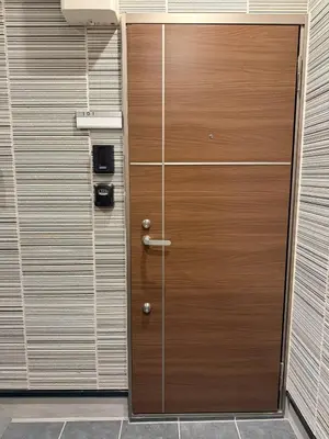 a wooden door in the side of a building at Nexus Villa Morishita in Tokyo