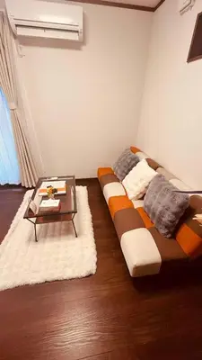 a bed in a room with a coffee table at Nexus Villa Morishita in Tokyo