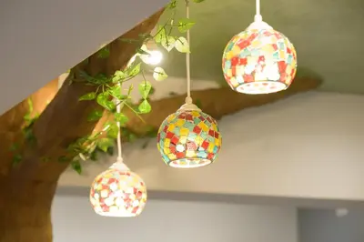 a group of three lights hanging from a ceiling at HANEZORA HOTEL itabashi 2F in Tokyo