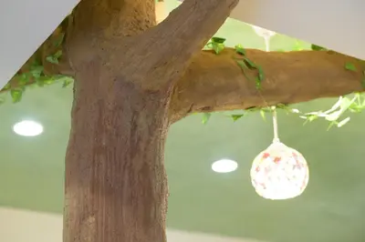 a tree with a christmas ornament hanging from it at HANEZORA HOTEL itabashi 2F in Tokyo