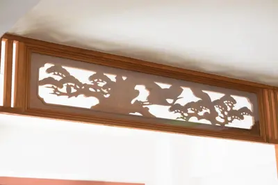 a shadow of a tree on a wall at HANEZORA HOTEL itabashi 2F in Tokyo