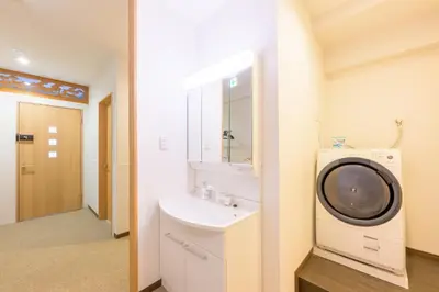 a bathroom with a sink and a washing machine at HANEZORA HOTEL itabashi 2F in Tokyo
