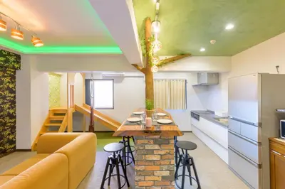 a kitchen and living room with a couch and a table at HANEZORA HOTEL itabashi 2F in Tokyo
