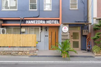 a blue building with a sign that reads hamza hotel at HANEZORA HOTEL itabashi 2F in Tokyo