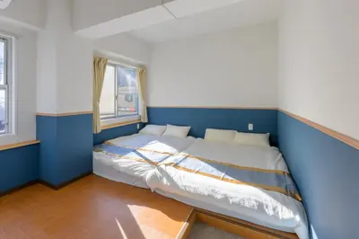a blue and white bedroom with a bed in it at HANEZORA HOTEL itabashi 2F in Tokyo