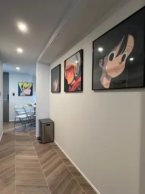 a hallway with four pictures on the wall at Koenji house, 2 bedrooms 2F 47m2, 5 min to Shinjuku in Tokyo