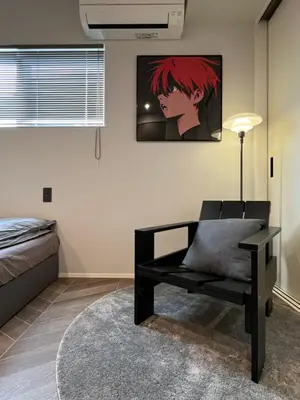 a bedroom with a bench and a painting on the wall at Koenji house, 2 bedrooms 2F 47m2, 5 min to Shinjuku in Tokyo