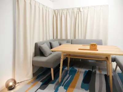 a living room with a couch and a wooden table at mstay\u677f\u6a4b\u99c5\u524d in Tokyo