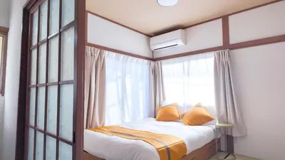 a bed in a room with a large window at mstay\u677f\u6a4b\u99c5\u524d in Tokyo
