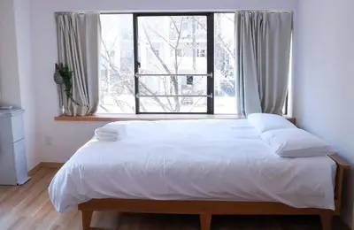 a bed in a room with a large window at SunRiseStay Asakusa Kaminarimon-dori\u6d45\u8349\u5546\u4e1a\u8857 \u96f7\u95e8\u901a in Tokyo