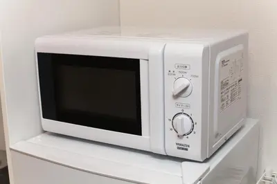 a white microwave oven sitting on a white shelf at Imb\u753a\u5c4b4\u4e01\u76ee301 in Tokyo