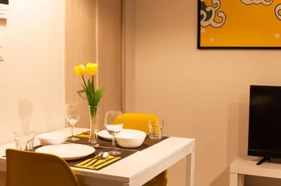 a dining room table with yellow flowers and glasses at Imb\u753a\u5c4b4\u4e01\u76ee301 in Tokyo