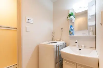 a bathroom with a sink and a toilet and a mirror at Imb\u753a\u5c4b4\u4e01\u76ee301 in Tokyo