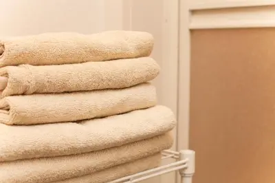a stack of towels on a rack in a bathroom at Imb\u753a\u5c4b4\u4e01\u76ee301 in Tokyo