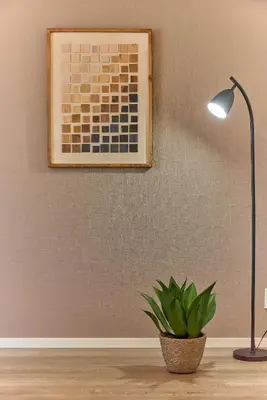 a lamp and a potted plant sitting on a table at VORT Yamabukicho Residence in Tokyo