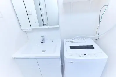 a white kitchen with a sink and a stove at VORT Yamabukicho Residence in Tokyo