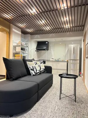 a living room with a couch and a table at HANEZORA HOTEL itabashi 1F in Tokyo