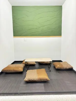 a room with five pillows and a green board at HANEZORA HOTEL itabashi 1F in Tokyo