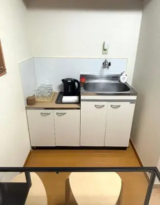 a small kitchen with a sink and a microwave at TOKYONATIVES Kugahara Base in Tokyo