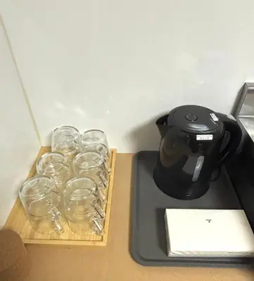 a coffee maker with glasses on a tray next to at TOKYONATIVES Kugahara Base in Tokyo