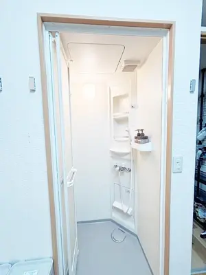 a small room with an open door to a refrigerator at TOKYONATIVES Kugahara Base in Tokyo