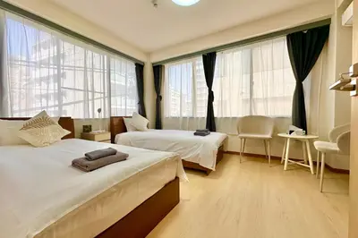 a hotel room with two beds and windows at Direct Skytree View I Easy Airport Access I New 2025 Building in Tokyo