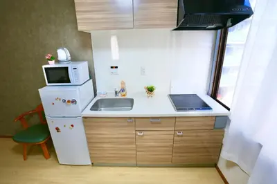 a small kitchen with a sink and a microwave at Direct Skytree View I Easy Airport Access I New 2025 Building in Tokyo