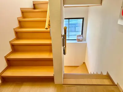 a stairwell with wooden steps and a window at Direct Skytree View I Easy Airport Access I New 2025 Building in Tokyo