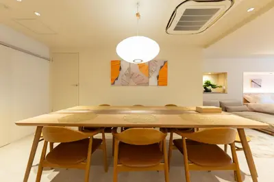 a dining room with a wooden table and chairs at THE AKI Daimon in Tokyo