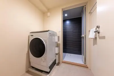 a washing machine in a bathroom with a shower at THE AKI Daimon in Tokyo