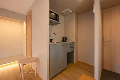 a kitchen with a counter and a stool in a room at 52A Kikyou NEW OPEN3 minutes from Ayase Station East Exit Modern Welcome to the family of students taking exams Private room rental 20 minutes to Ueno Asakusa in Tokyo
