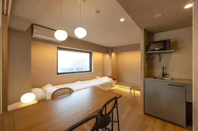 a living room with a couch and a table at 52A Kikyou NEW OPEN3 minutes from Ayase Station East Exit Modern Welcome to the family of students taking exams Private room rental 20 minutes to Ueno Asakusa in Tokyo