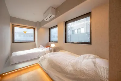 a bedroom with two beds and two windows at 52A Kikyou NEW OPEN3 minutes from Ayase Station East Exit Modern Welcome to the family of students taking exams Private room rental 20 minutes to Ueno Asakusa in Tokyo
