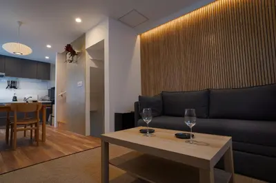 a living room with a couch and a table at Besso Ebisu in Tokyo