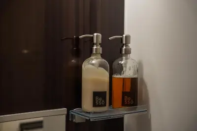 two bottles of alcohol are sitting on a shelf at Besso Ebisu in Tokyo