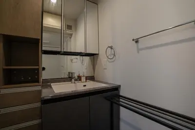 a small kitchen with a sink and a mirror at Besso Ebisu in Tokyo