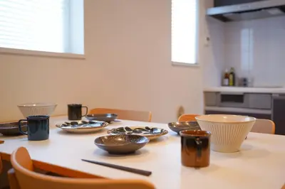 a dining room table with bowls and utensils on it at Besso Ebisu in Tokyo