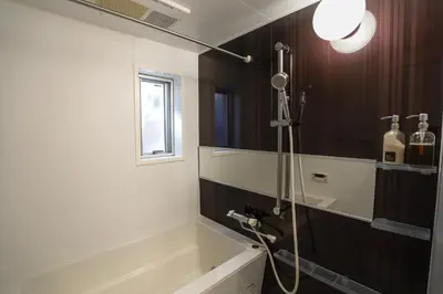 a bathroom with a shower and a bath tub at Besso Ebisu in Tokyo