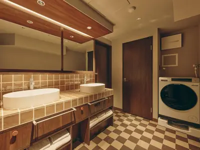 a bathroom with two sinks and a washing machine at illi Nuto Shinjuku in Tokyo