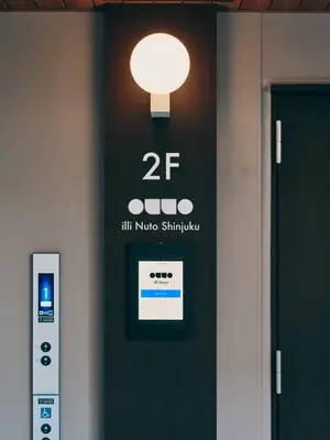 a sign on a door with a light on it at illi Nuto Shinjuku in Tokyo