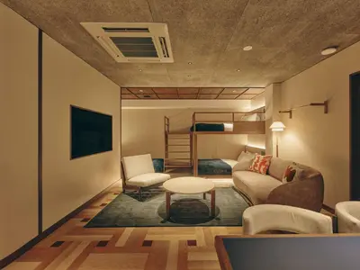 a living room with a couch and a bunk bed at illi Nuto Shinjuku in Tokyo