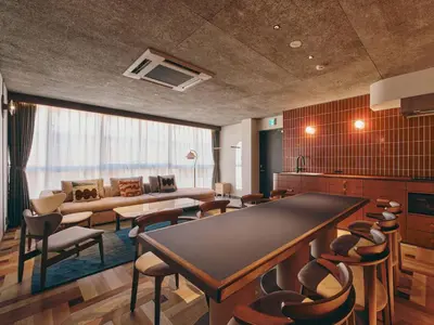 a living room with a large table and chairs at illi Nuto Shinjuku in Tokyo