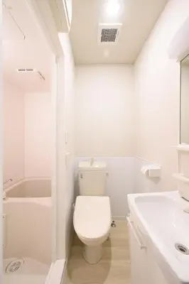 a white bathroom with a toilet and a sink at Kohoku Apartment in Tokyo