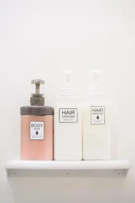 a shelf with three bottles ofodorizers on it at Kohoku Apartment in Tokyo