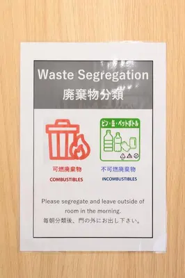 a sign that says waste segregation and leave outside of room in the morning at Kohoku Apartment in Tokyo