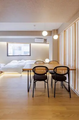 a room with a table and chairs and a bed at 41A Sakura NEW OPEN 3 minutes from the east exit of Ayase Station Japanese modern sophisticated space private room Ueno and Asakusa 20 minutes in Tokyo